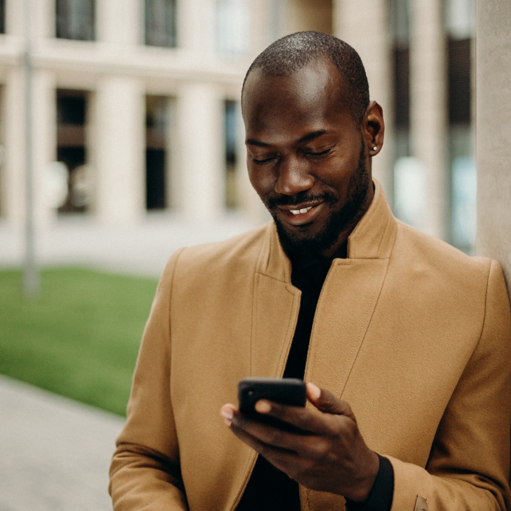 Man checking his mobile, whilst on the move